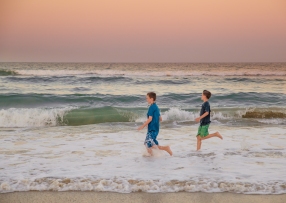 Children running in the ocean Outer Banks OBX